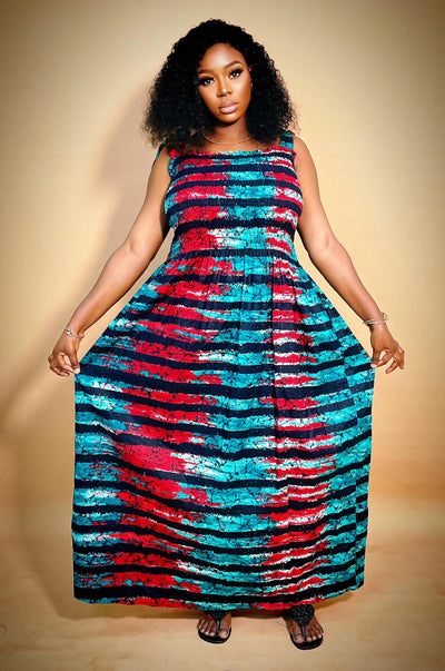 Woman wearing a colorful sleeveless African Print Maxi Dress on a beige background