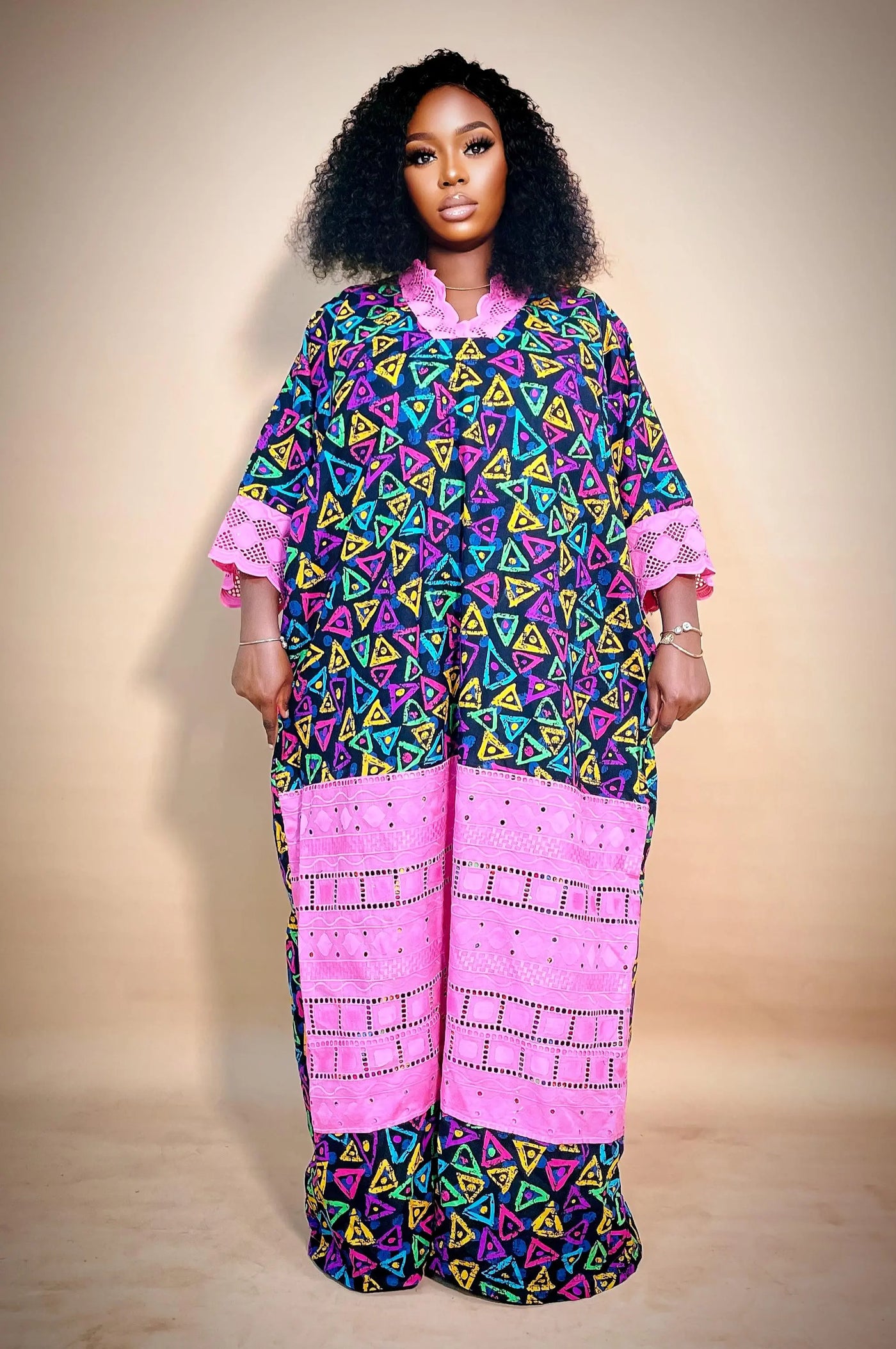 Woman wearing the Latest Ankara Bubu Gown Style with geometric patterns on a beige background