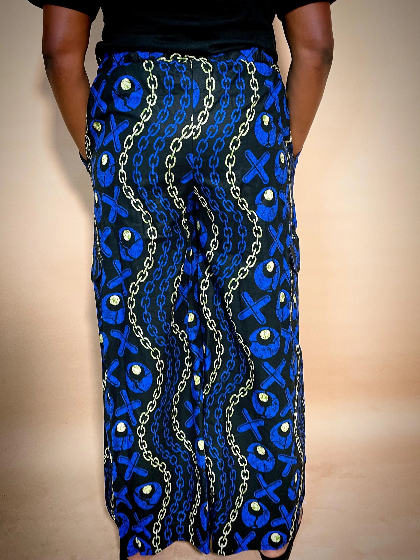 Blue patterned Ankara print baggy pant with gold chain details on a neutral background