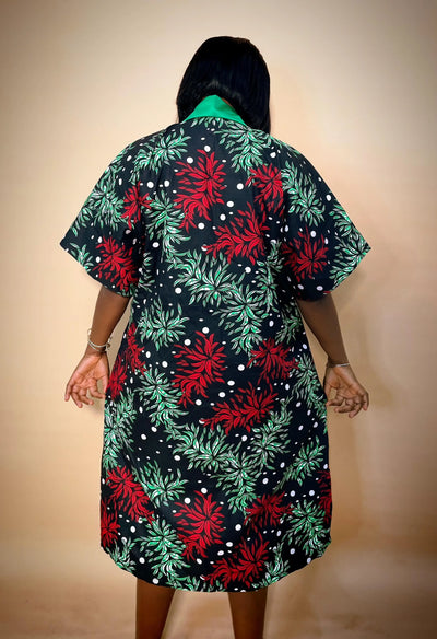 Back view of a Person wearing a green Stylish African Outfit with black floral pattern on a beige background