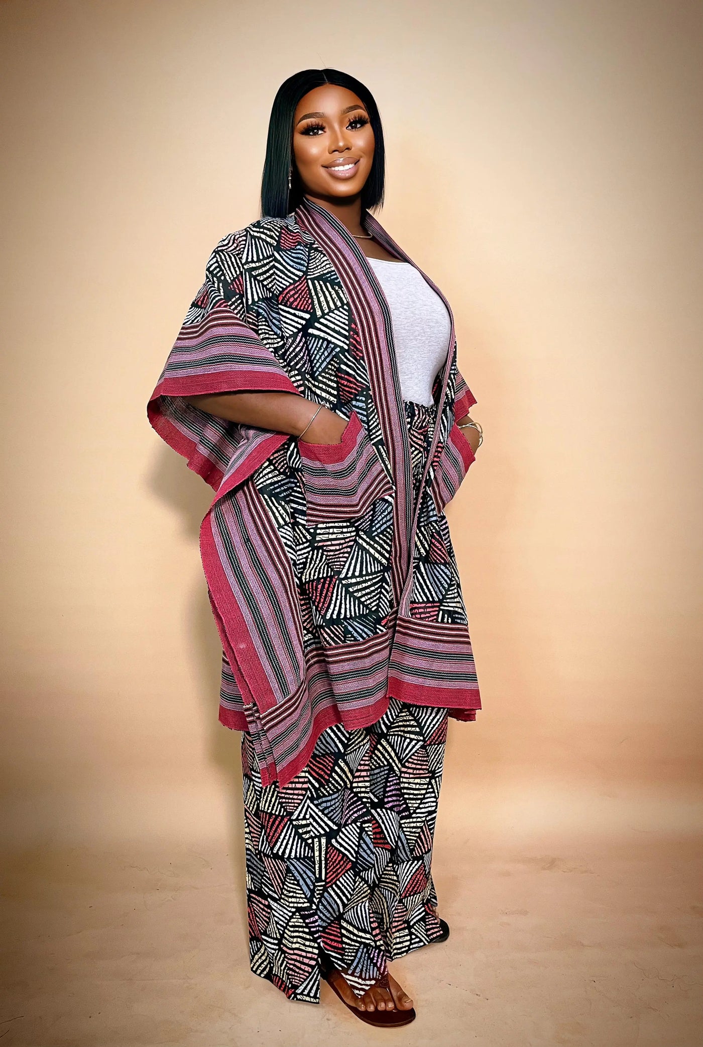 Woman wearing a patterned outfit with a beige background