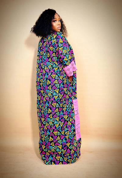 Woman wearing the Latest Ankara Bubu Gown Style with geometric patterns on a beige background