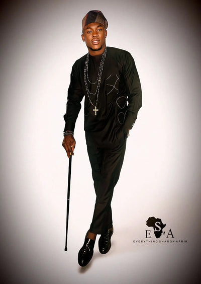 Man in black African Senator Long Sleeve Set with a cane on a gray background, featuring the brand 'E S A'.