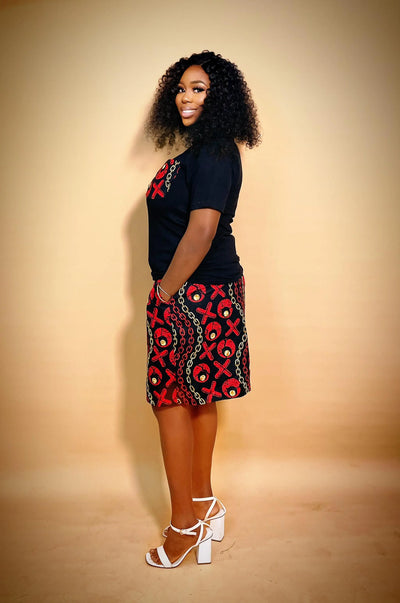 Side view of woman wearing an Ankara Matching Set for Women with green patterns on a beige background