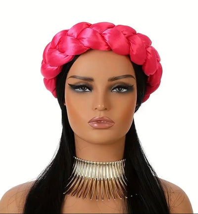Mannequin head with pink braided satin headband scarf and long black hair on a white background