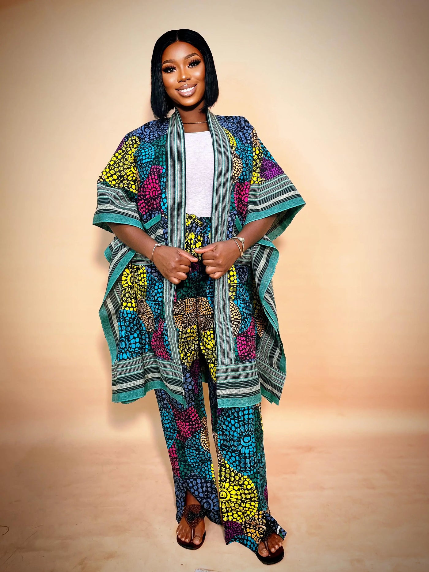 Woman wearing a colorful African Kimono & Palazzo Two Piece style on a beige background