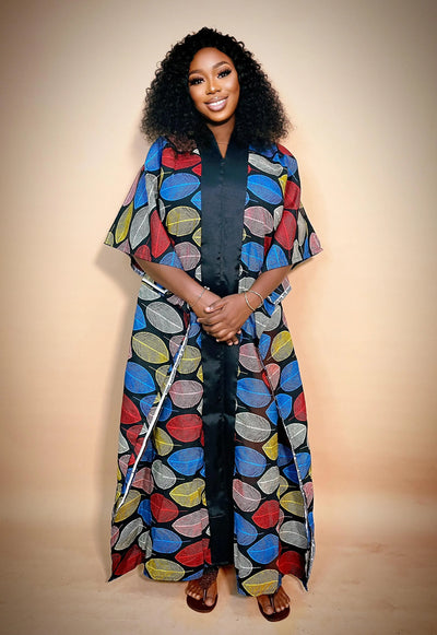 Woman wearing a colorful Ankara Bubu Gown for women with a plain background