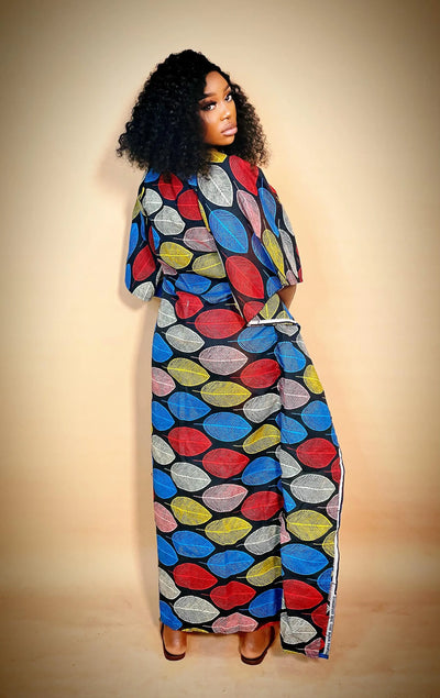 Woman wearing a colorful Ankara Bubu Gown for women with a plain background