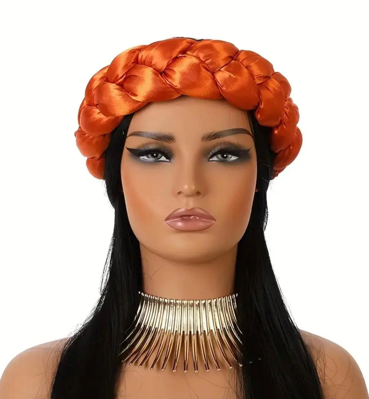 Mannequin head with orange braided satin headband scarf and long black hair on a white background