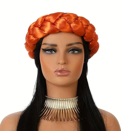 Mannequin head with orange braided satin headband scarf and long black hair on a white background