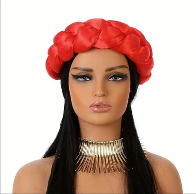 Mannequin head with red satin headband scarf and long black hair on a white background